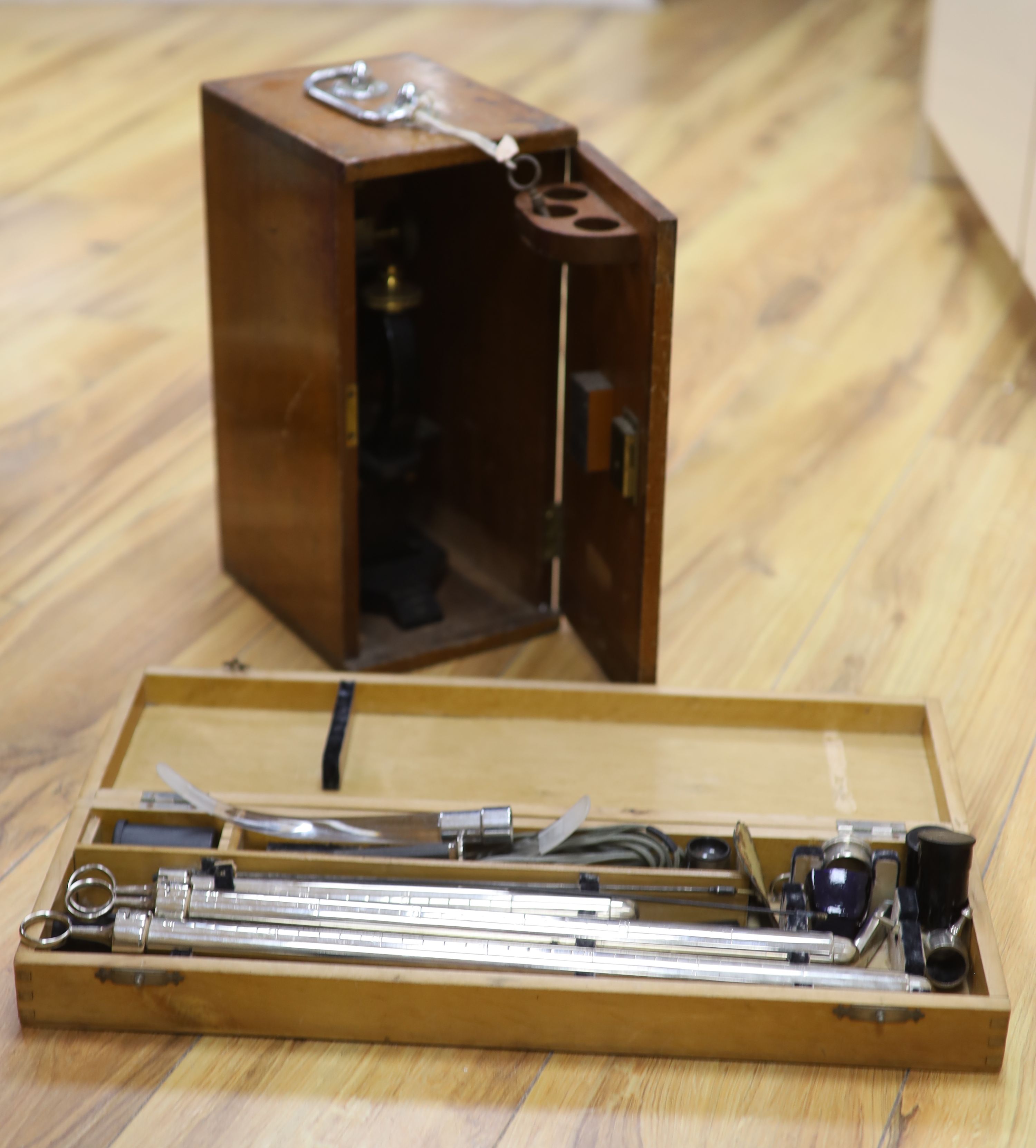 A mahogany cased microscope and veterinary equipment